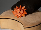 a hat with a flower on top of it on a chair