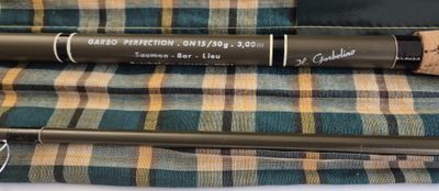 a close up of two different types of fishing rods on a table