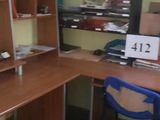 an image of a room with a desk and a chair