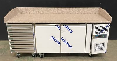 an image of a kitchen with a counter and refrigerator