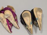 three pairs of shoes are lined up on a white surface