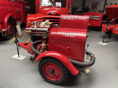 a red fire truck that is parked in a garage