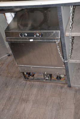 a stainless steel dishwasher sitting on a counter