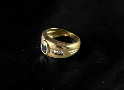 a close up of a gold ring on a black surface