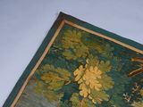 a picture of a wall hanging with a bird and flowers on it