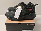 the black sneakers are on a box with a price tag