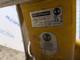 a close up of a parking meter with a sticker on it