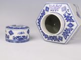 a blue and white vase and a box on a white surface