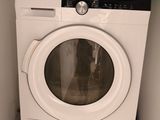 a washer and dryer in the corner of a room