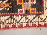 a close up of a red, black, and yellow area rug
