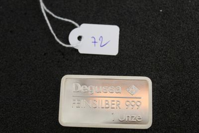 a metal tag with a name on it on a black surface