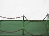 a green tray with a chain attached to it