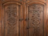 an image of a large wooden door with intricate carvings
