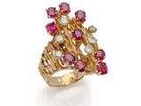 un gros plan d'une bague en or sertie de rubis et de diamants