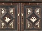 a wooden cabinet with carvings on the doors