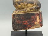 an image of a statue of a person sitting on top of a block