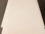 an image of a white lounge chair in a room