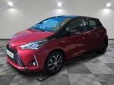 a red toyota yaris parked on a checkered floor
