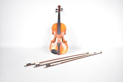 an orange violin sitting next to a pair of wooden sticks