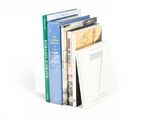 books are stacked on top of each other on a white surface