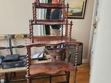 a wooden shelf with a mirror on it in a living room