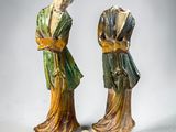 pair of chinese figurines of a woman and a man with a dog
