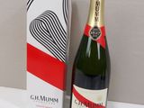 a bottle of champagne next to a box on a table