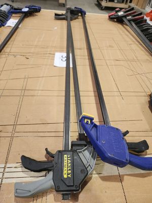 une pince posée par terre à côté d'une paire d'outils