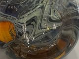 a glass bowl with an orange in it sitting on a table