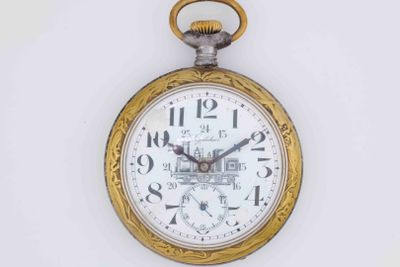 a gold pocket watch hanging on a white wall