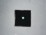 a small black square with a green light in it