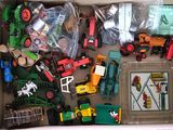 a box full of toy trains and other toy vehicles