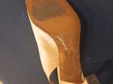 the bottom of a pair of wooden shoes on a blue chair