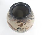 a black and white vase with a painting of birds on it