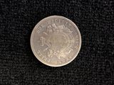 a silver coin sitting on top of a black cloth