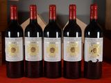 four bottles of wine are lined up on a table