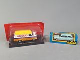 two toy cars that are next to each other on a table