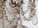 a chandelier hanging from the ceiling with a bunch of crystal beads