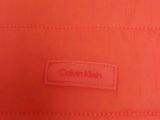 a close up of a red bag with a label on it