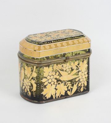 une petite boîte noire et jaune décorée de fleurs