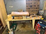 a workbench that has a lot of tools on it