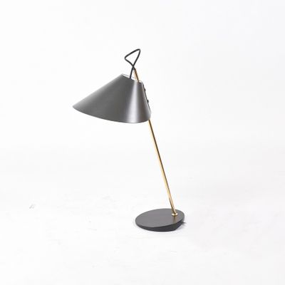 a black and gold lamp on a white background