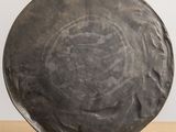 a large black plate on a stand on a table