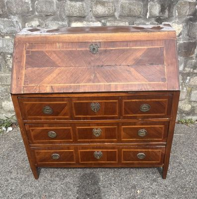 a wooden dresser with drawers and drawers on top of it