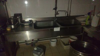 a kitchen with a sink, stove, and other items on the counter