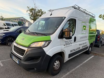a green and white van parked in a parking lot