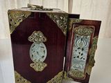 a small wooden box with a clock inside of it