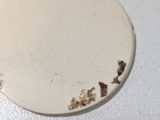 a close up of a white plate with some dirt on it