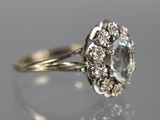a close up of a diamond ring on a reflective surface