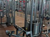 a gym with a lot of machines in the room
